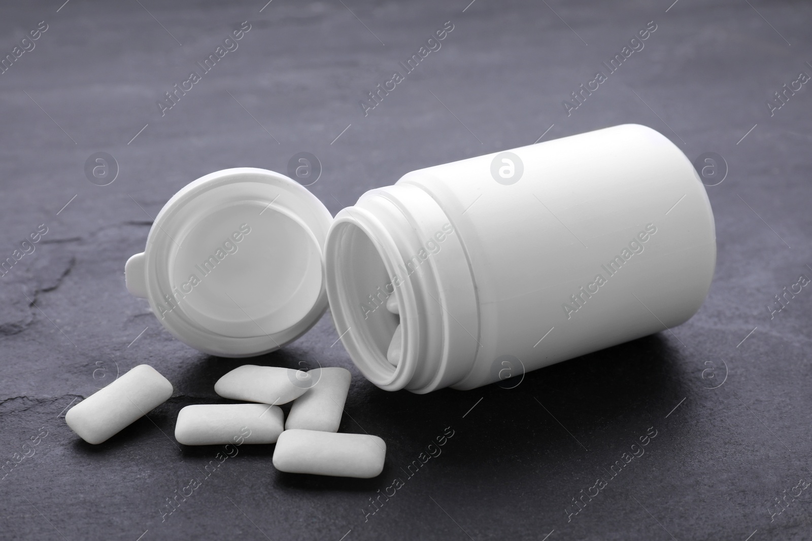 Photo of Jar with chewing gums on grey table