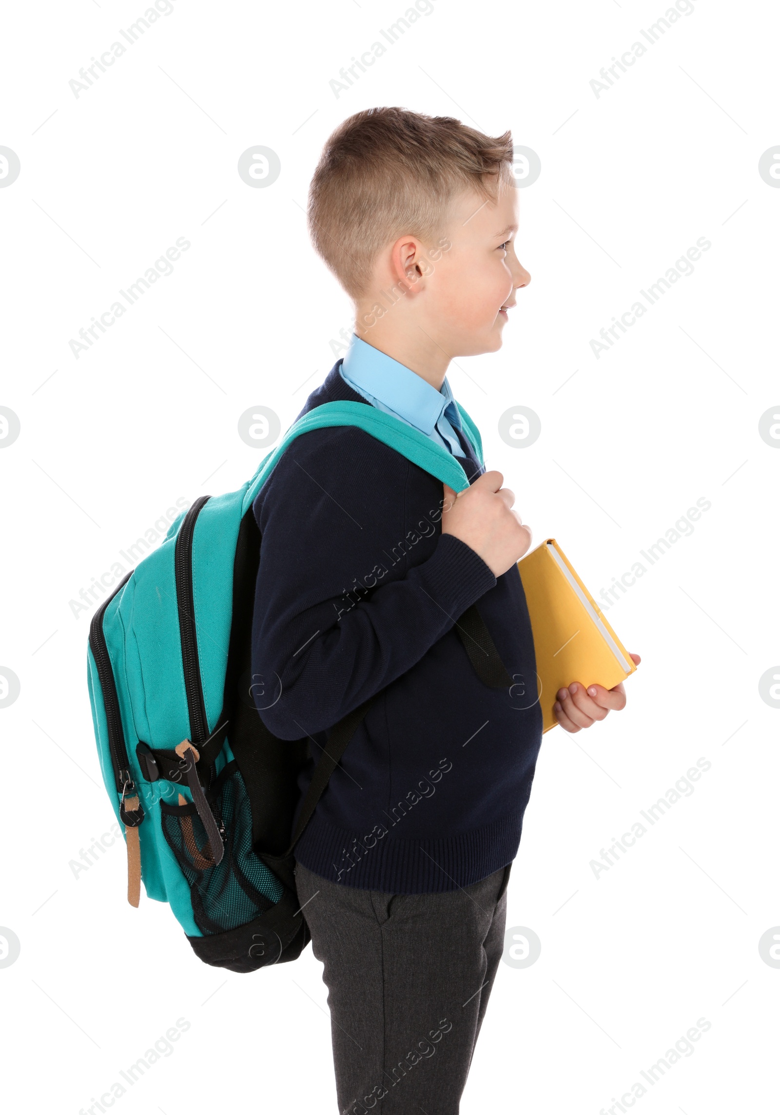 Photo of Portrait of cute boy in school uniform on white background