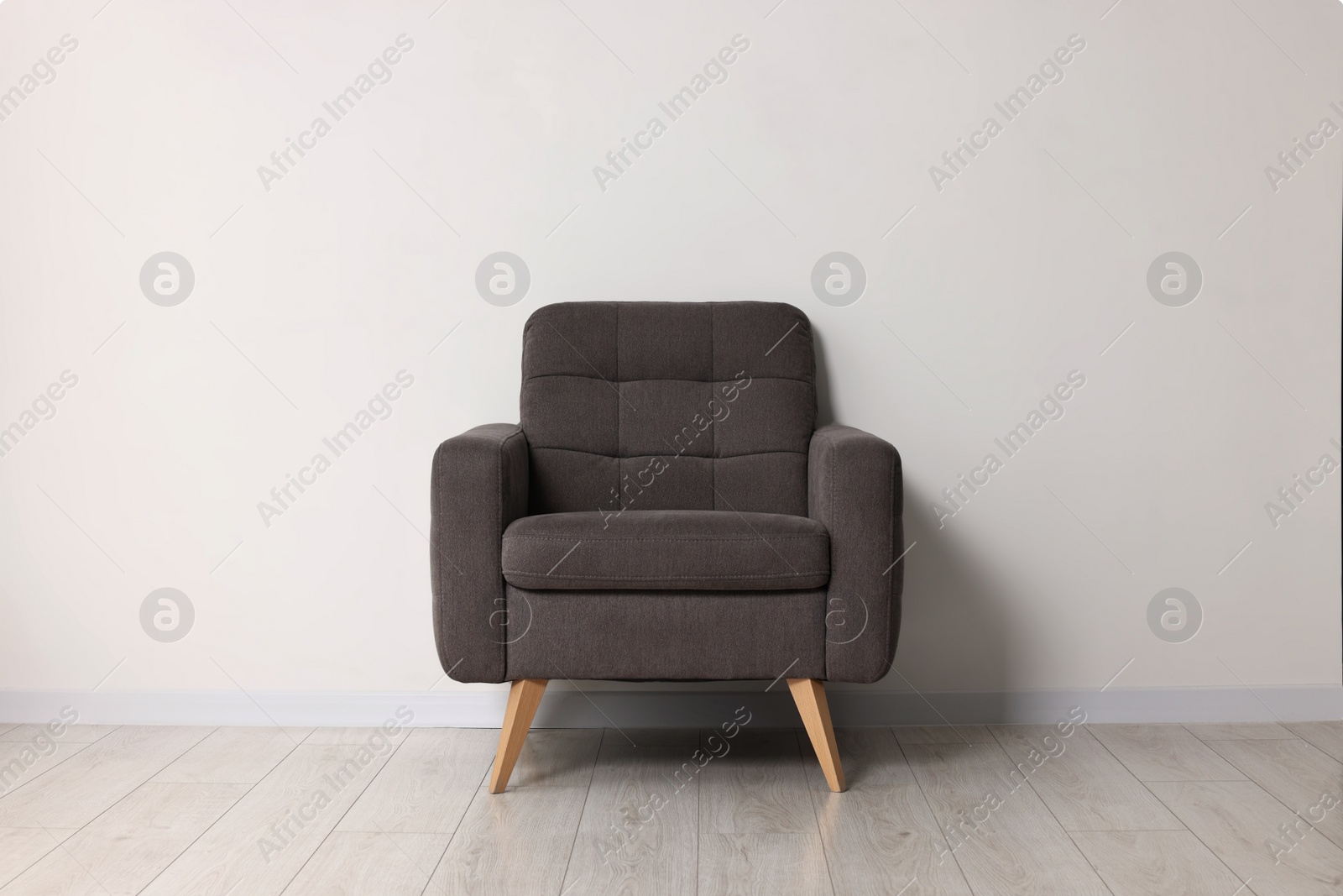 Photo of Comfortable armchair near white wall in room