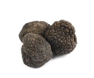 Photo of Fresh whole black truffles isolated on white