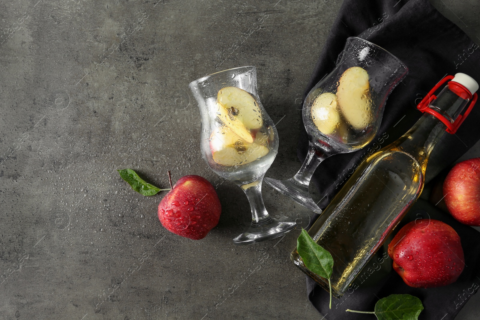 Photo of Flat lay composition with delicious apple cider on gray table, space for text