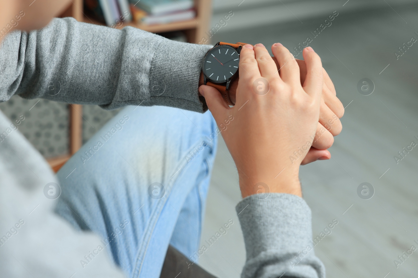 Photo of Man checking time in room, closeup. Being late