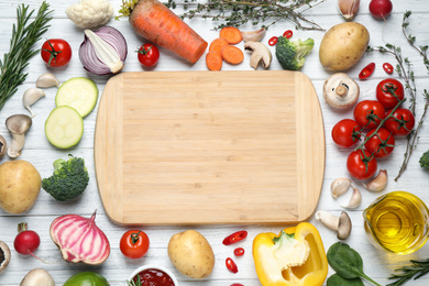 Flat lay composition with fresh products on white wooden table, space for text. Healthy cooking