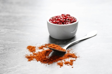 Photo of Ground red pepper and corns on grey table