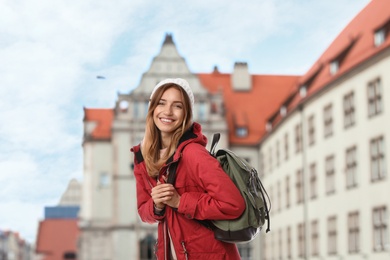 Image of Happy traveler with backpack in foreign city during vacation