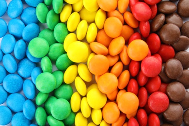 Many colorful candies as background, top view