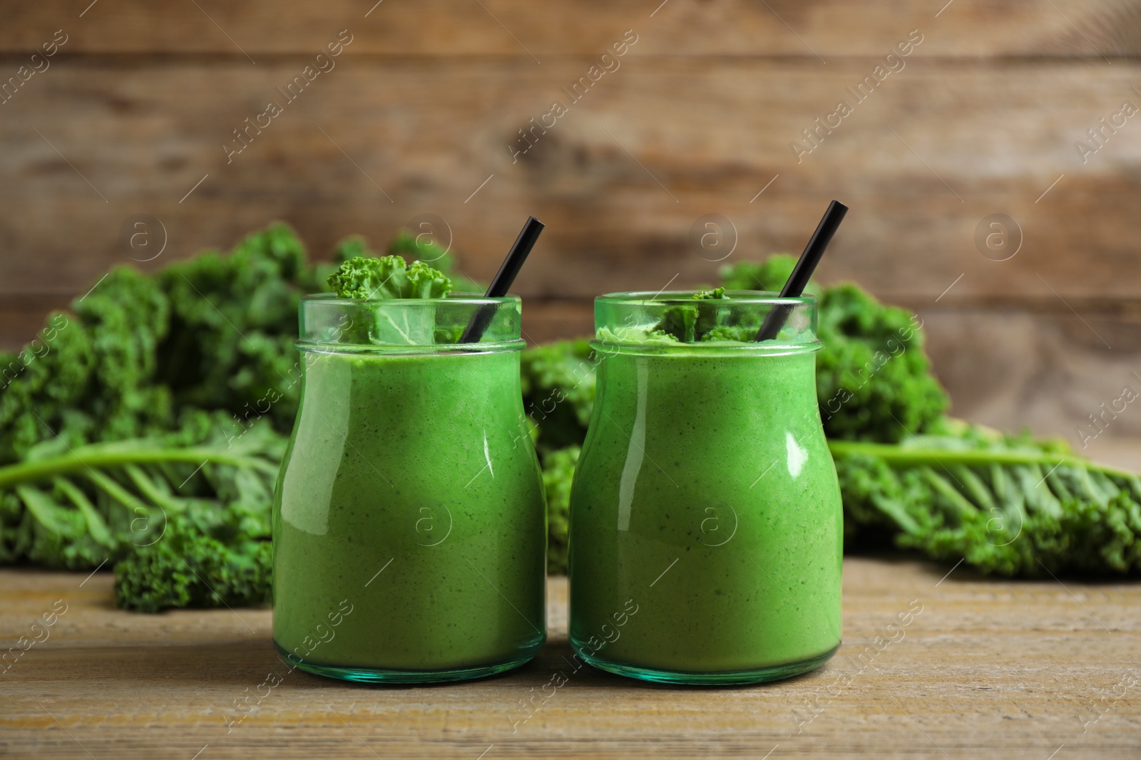 Photo of Tasty fresh kale smoothie on wooden table