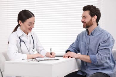 Doctor consulting patient during appointment in clinic