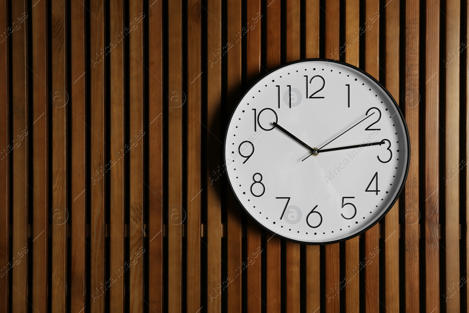 Photo of Stylish clock and space for text on wooden background. Time management