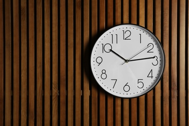 Stylish clock and space for text on wooden background. Time management