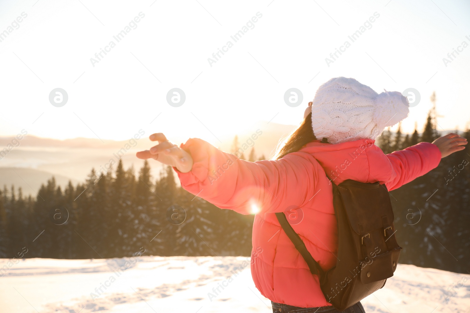 Photo of Happy young woman outdoors on snowy winter day