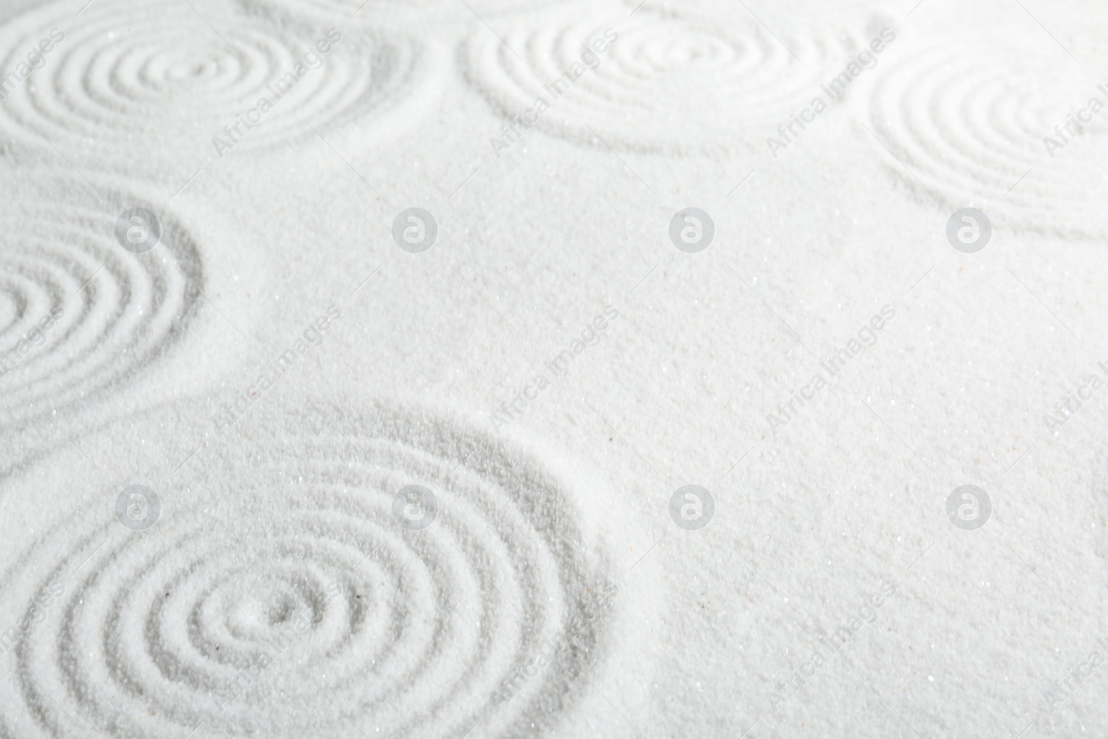 Photo of Zen rock garden. Circle patterns on white sand