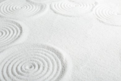 Photo of Zen rock garden. Circle patterns on white sand
