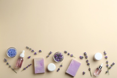Flat lay composition of handmade soap bars with lavender flowers and ingredients on beige background. Space for text