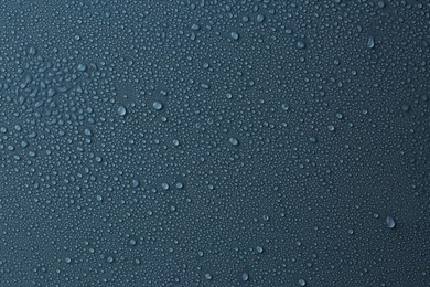 Photo of Many water drops on dark dusty blue background