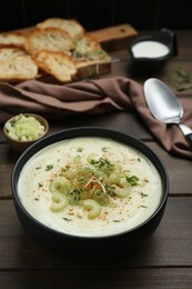 Photo of Bowl of delicious celery soup on wooden table