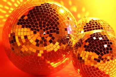 Closeup view of shiny disco balls, toned in orange