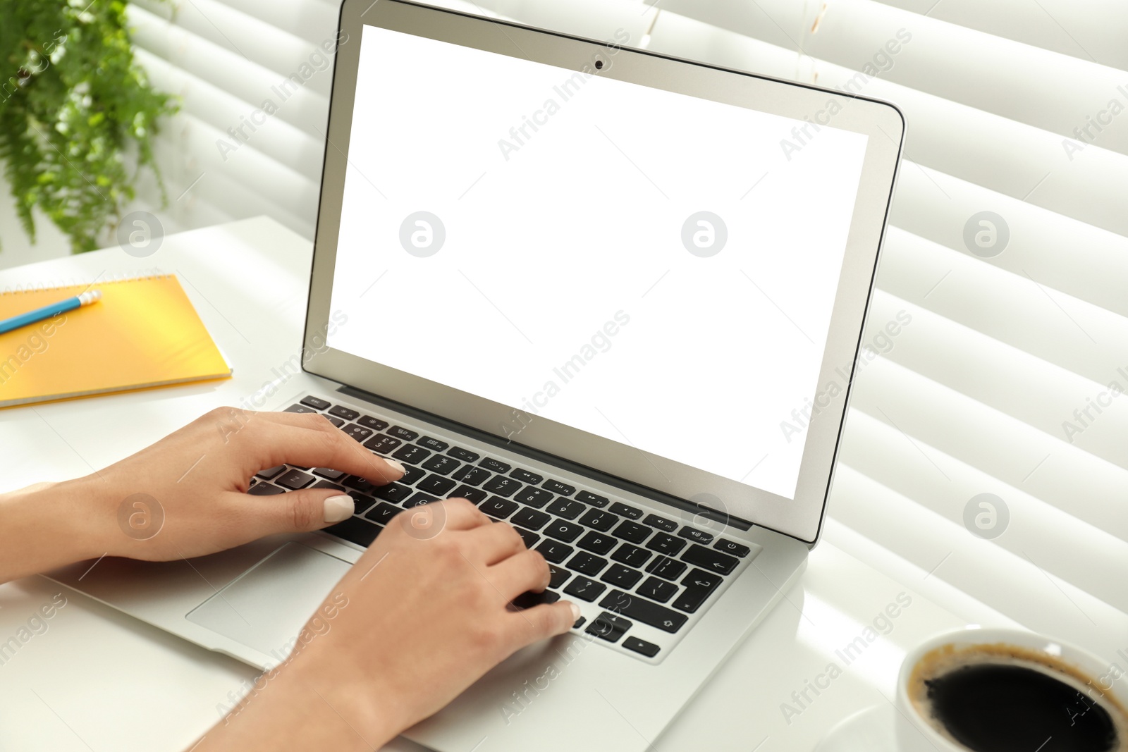 Image of Young woman using modern computer at table in office, closeup. Space for design