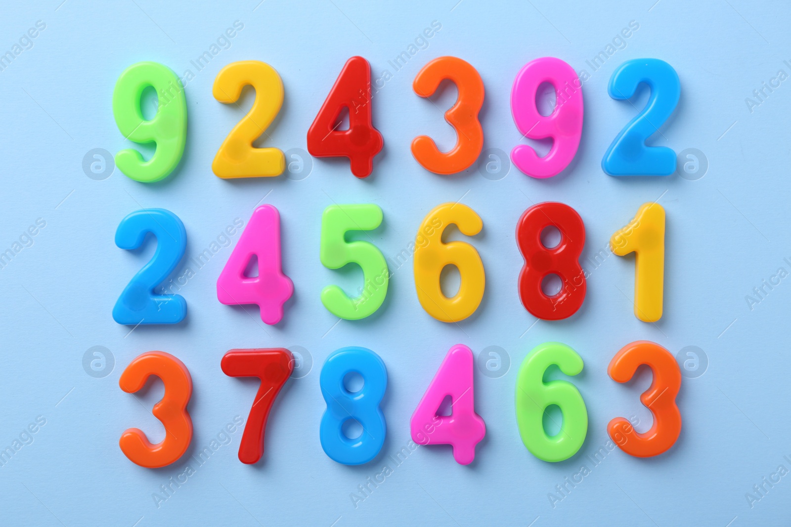 Photo of Colorful numbers on blue background, flat lay