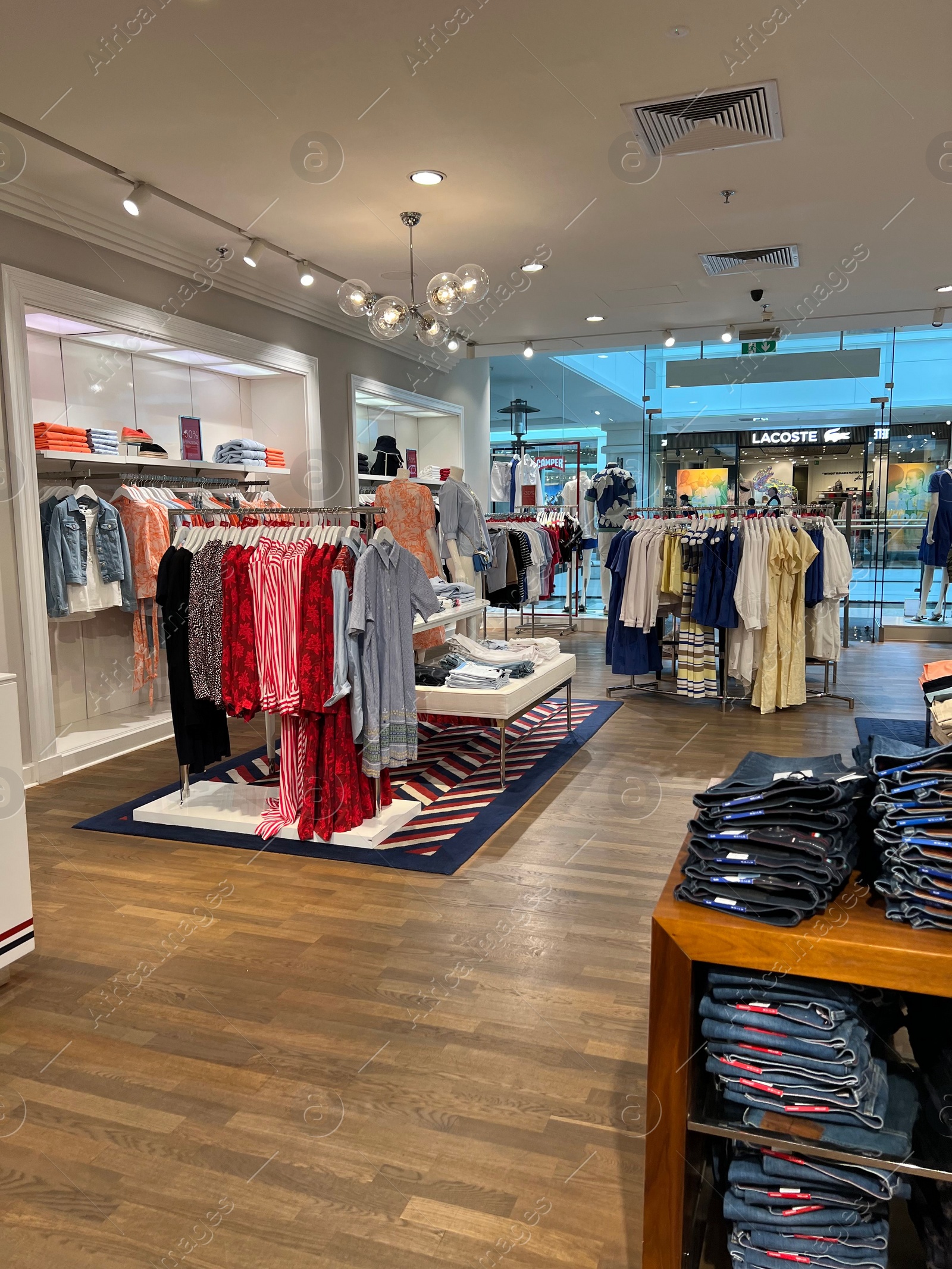 Photo of WARSAW, POLAND - JULY 13, 2022: Store interior with stylish clothes, shoes and accessories in shopping mall