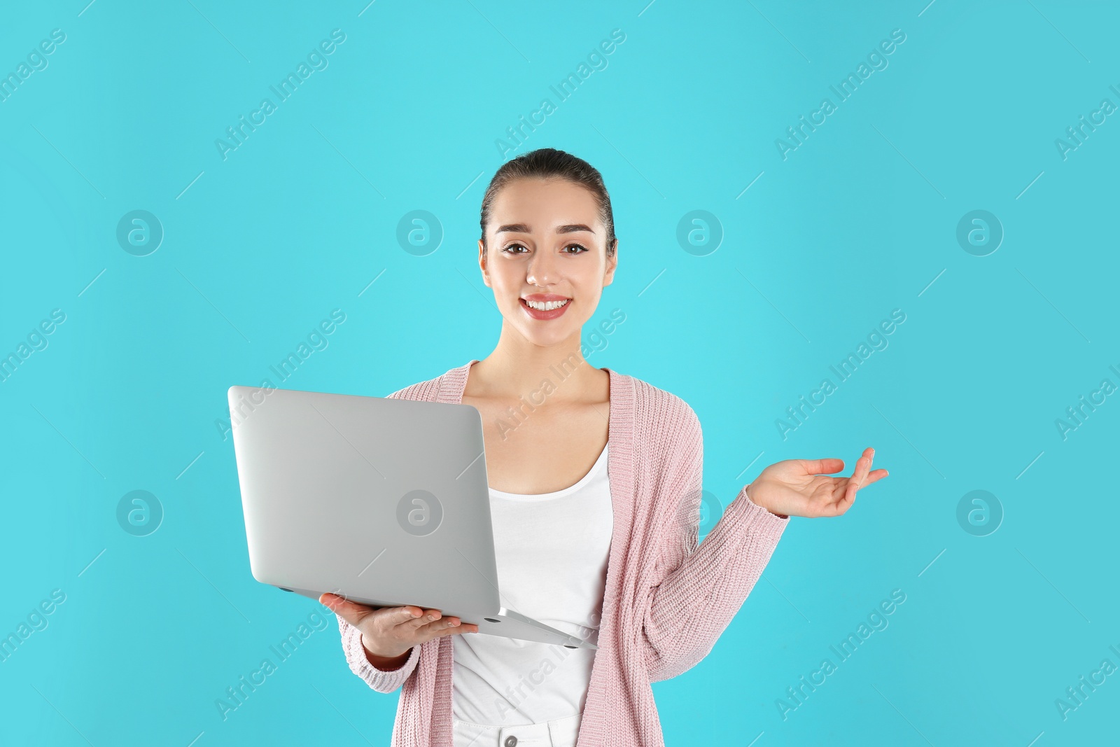 Photo of Portrait of young woman in casual outfit with laptop on color background