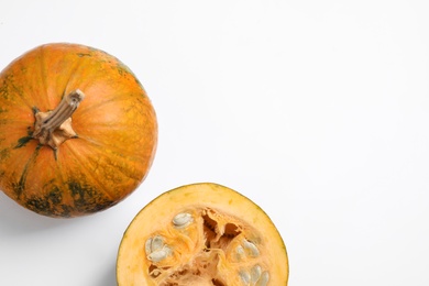 Photo of Fresh ripe pumpkins on white background, top view. Holiday decoration