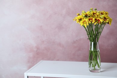 Photo of Vase with beautiful chrysanthemum flowers on white table. Space for text