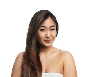 Photo of Portrait of beautiful Asian woman wrapped in towel isolated on white. Spa treatment