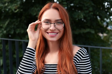 Photo of Portrait of beautiful woman in glasses outdoors