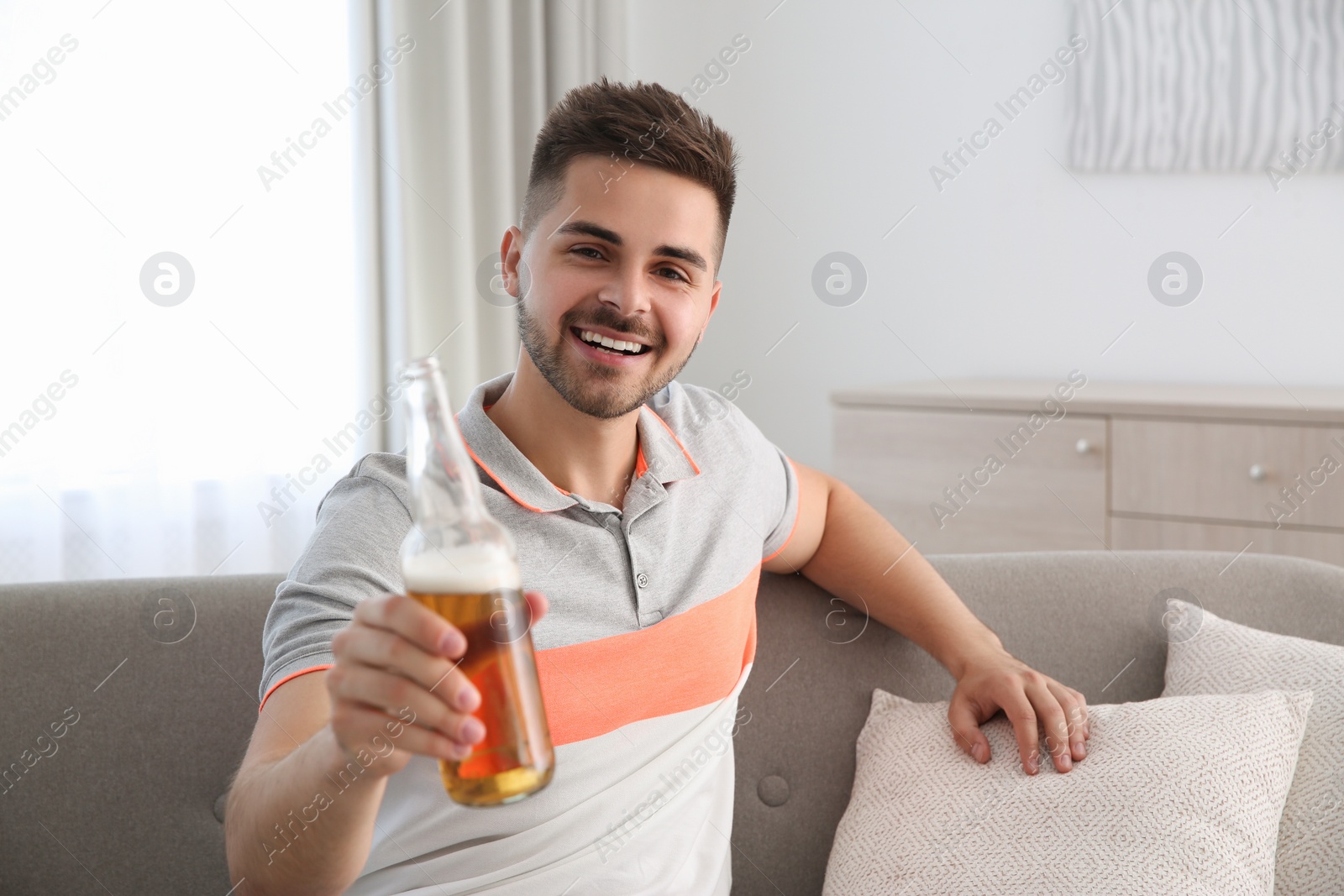 Photo of Man drinking beer while having online video conference at home, view from web camera. Social distancing during coronavirus pandemic