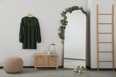 Photo of Stylish room interior with leaning floor mirror