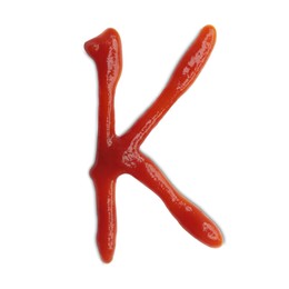 Photo of Letter K written with ketchup on white background