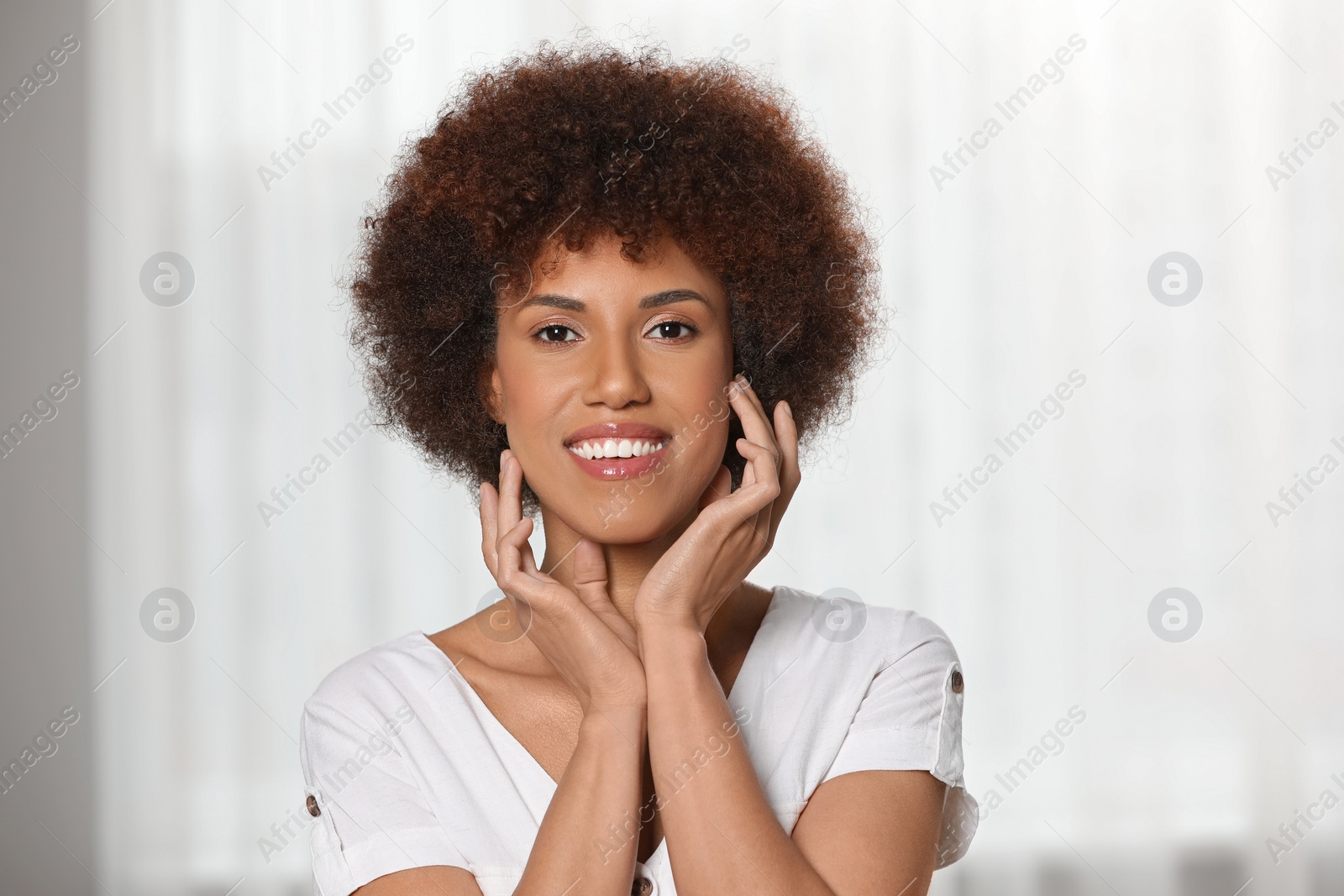 Photo of Portrait of beautiful young woman near window indoors