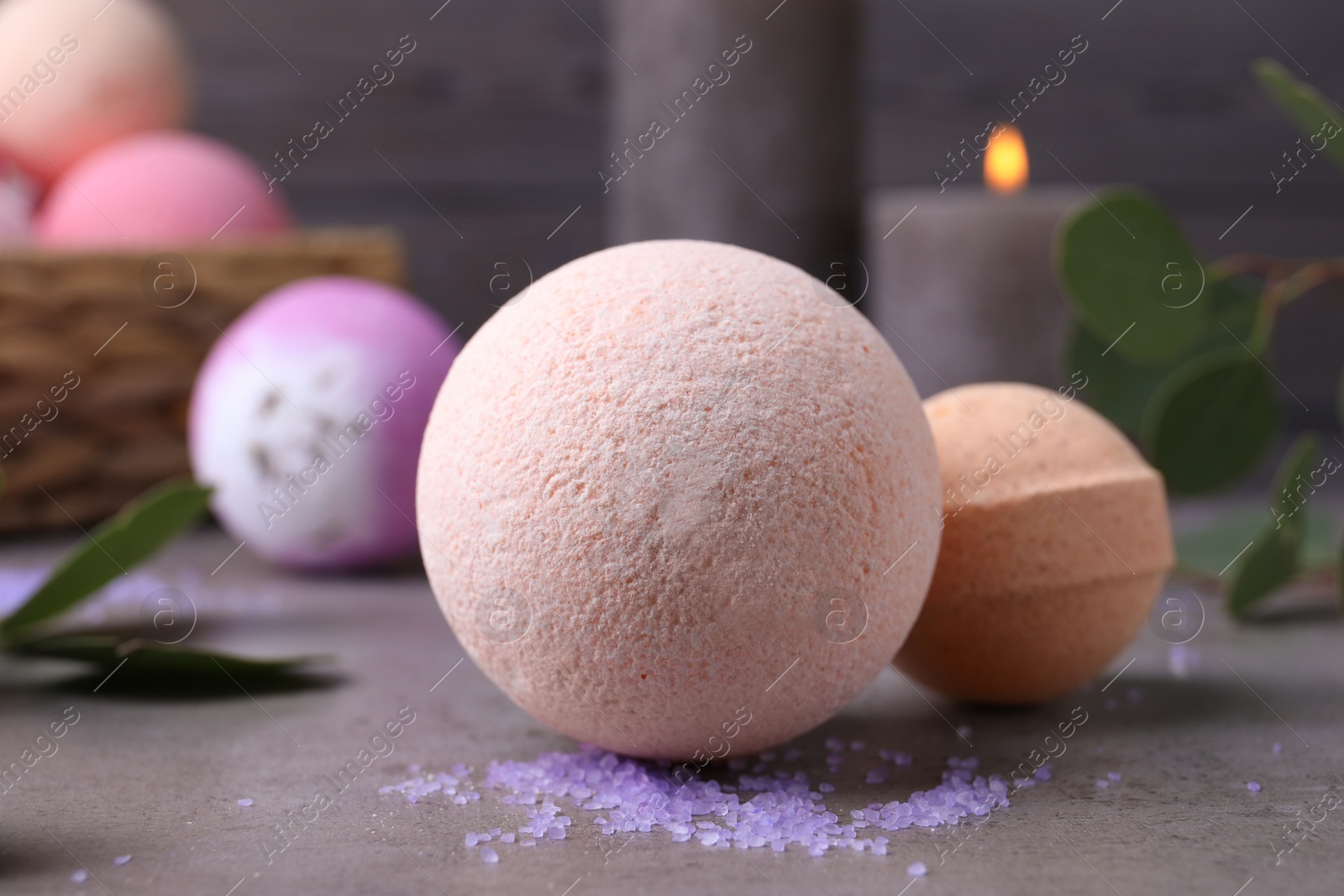 Photo of Beautiful aromatic bath bombs on grey table, closeup