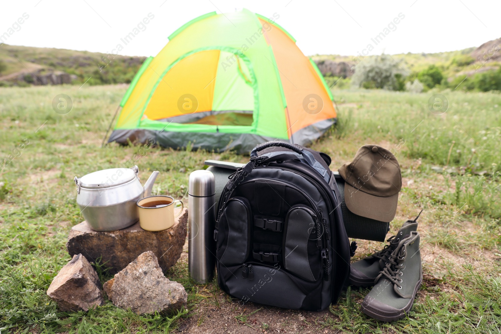 Photo of Camping gear and tourist tent in wilderness
