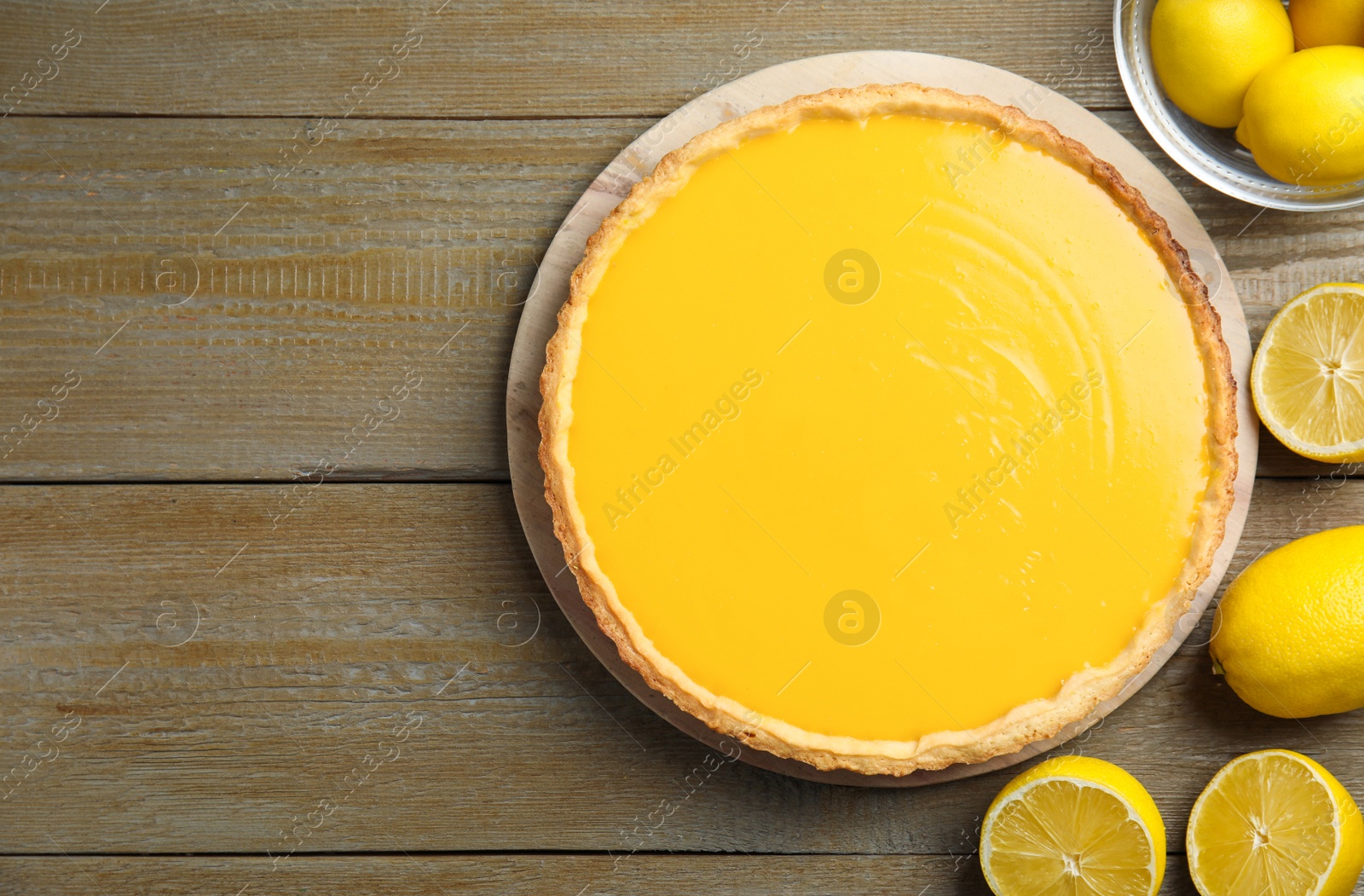 Photo of Delicious homemade lemon pie with mint on wooden table, flat lay. Space for text