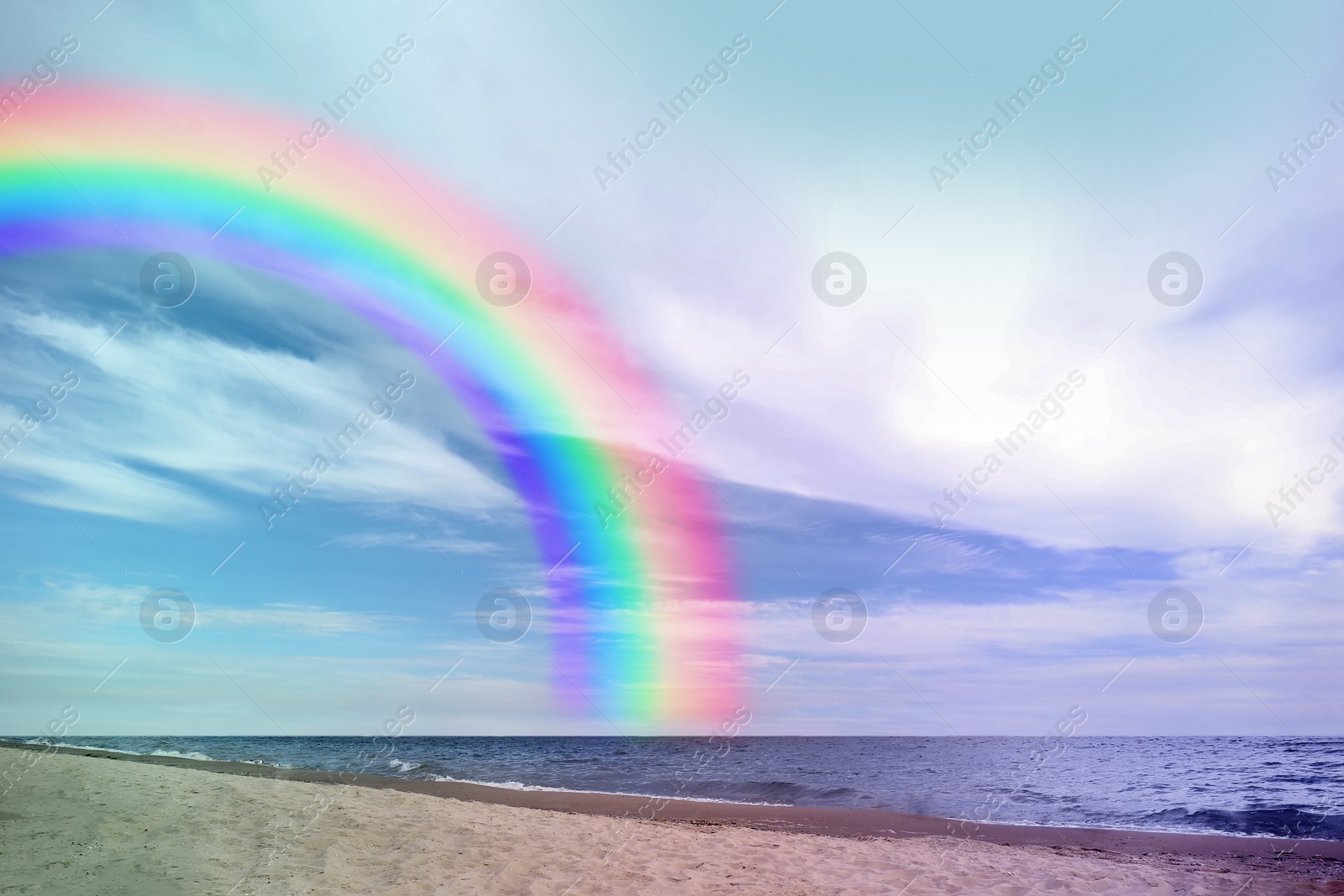 Image of Beautiful view of colorful rainbow in sky over sea