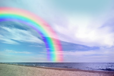 Image of Beautiful view of colorful rainbow in sky over sea