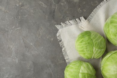 Photo of Ripe white cabbage on grey table, flat lay. Space for text