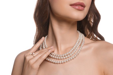 Photo of Young woman with elegant pearl jewelry on white background, closeup