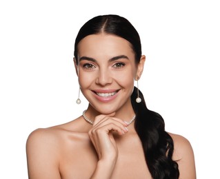 Young woman wearing elegant pearl jewelry on white background
