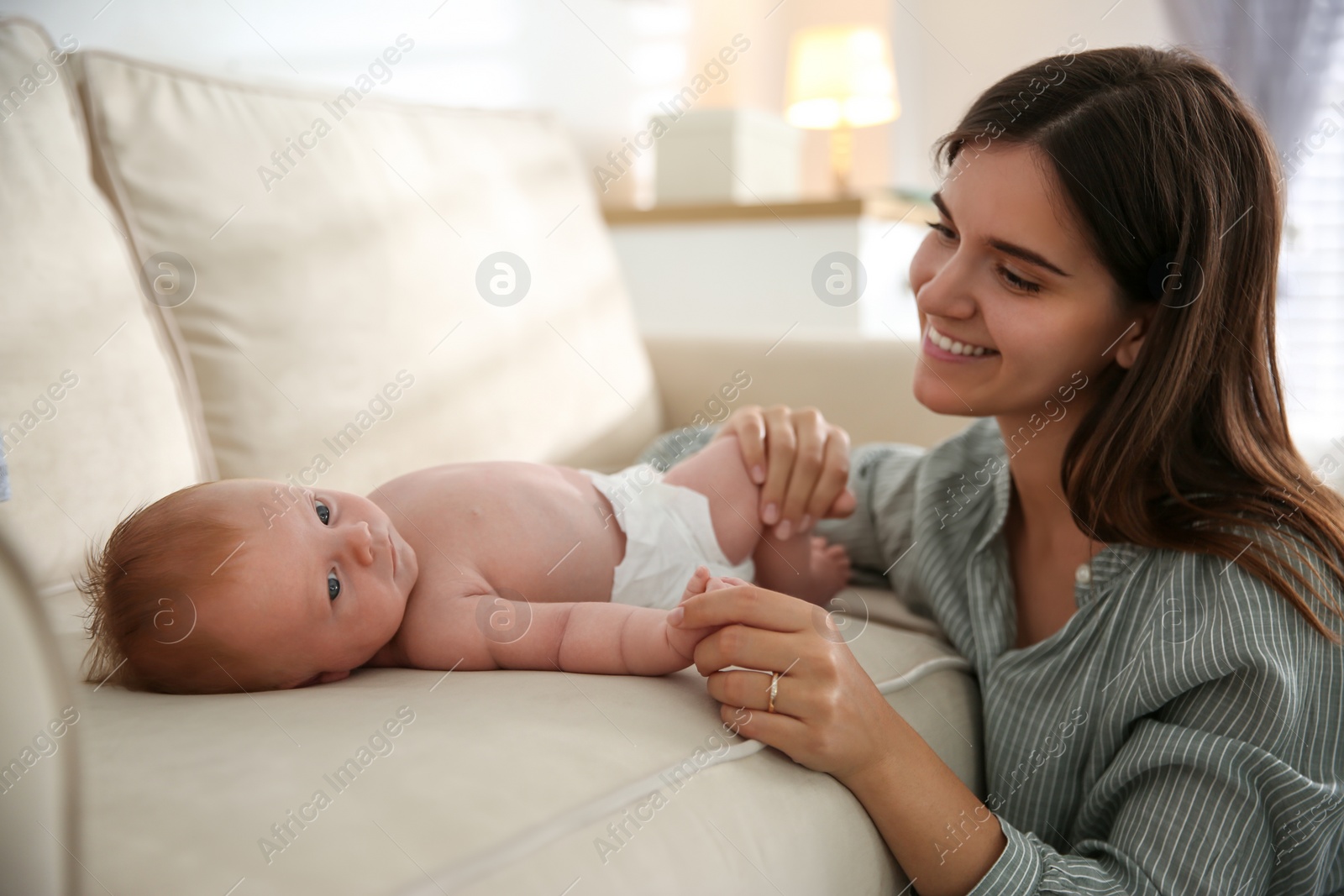 Photo of Mother with her newborn baby at home