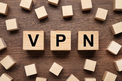 Cubes with acronym VPN on wooden table, flat lay