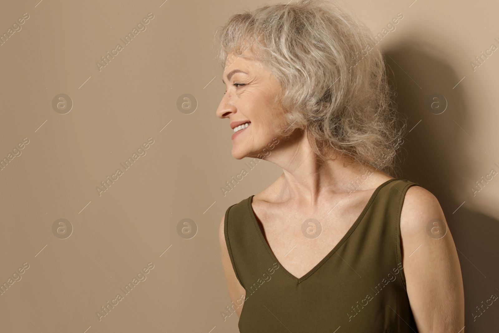 Photo of Portrait of mature woman on color background. Space for text