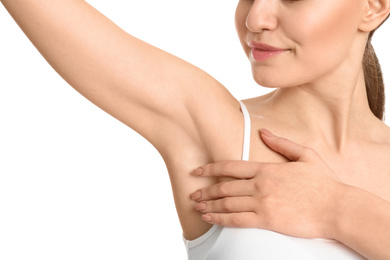 Young woman showing armpit with smooth clean skin on white background, closeup