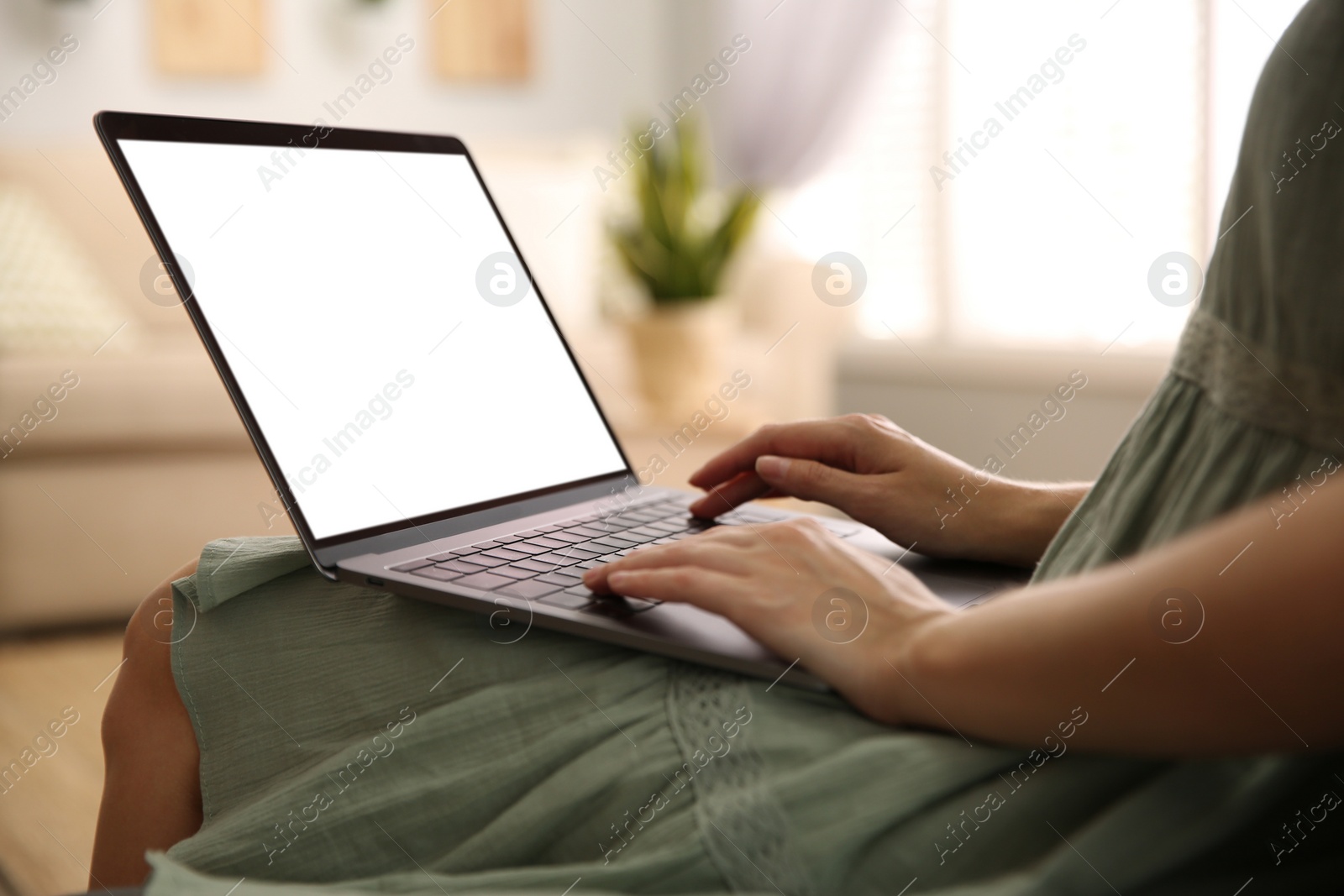 Photo of Woman using laptop at home, closeup. Space for design