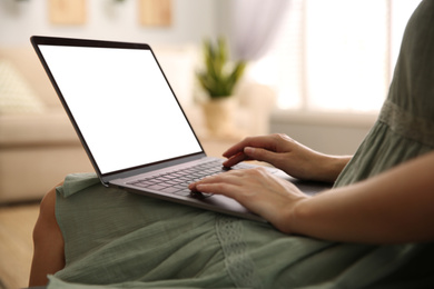 Photo of Woman using laptop at home, closeup. Space for design