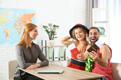 Photo of Beautiful young couple visiting travel agency office