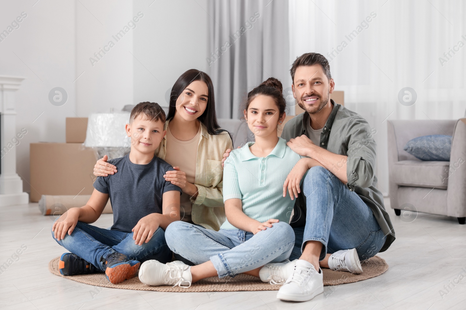 Photo of Happy family spending time in new apartment. Moving day