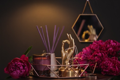 Composition with stylish accessories, flowers and interior elements on table indoors